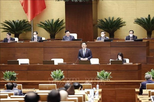 Minister of Industry and Trade Nguyen Hong Dien (standing) at the NA Standing Committee’s question-and-answer session on March 16. (Photo: VNA)