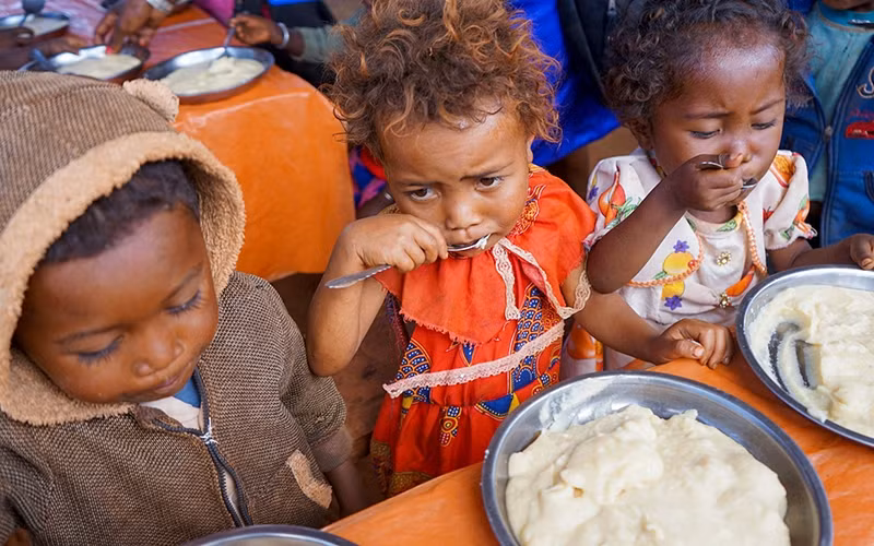 Children in Madagascar receive food aid.