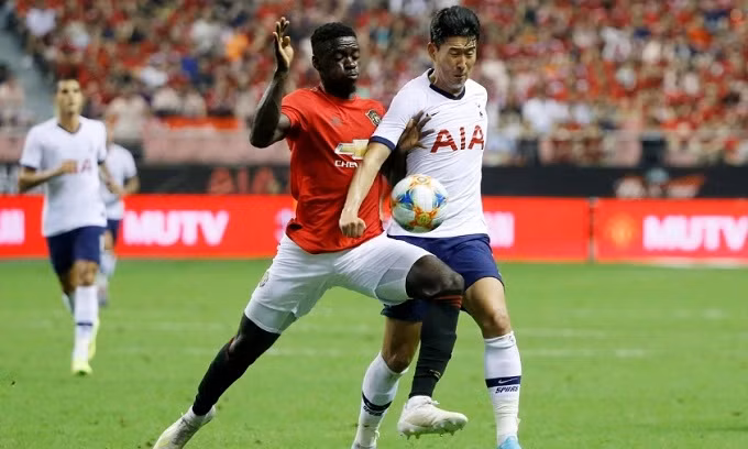 Soccer Football - International Champions Cup - Tottenham Hotspur v Manchester United - Hongkou Football Stadium, Shanghai, China - July 25, 2019 Manchester United's Axel Tuanzebe in action with Tottenham Hotspur's Son Heung-Min. (Reuters)