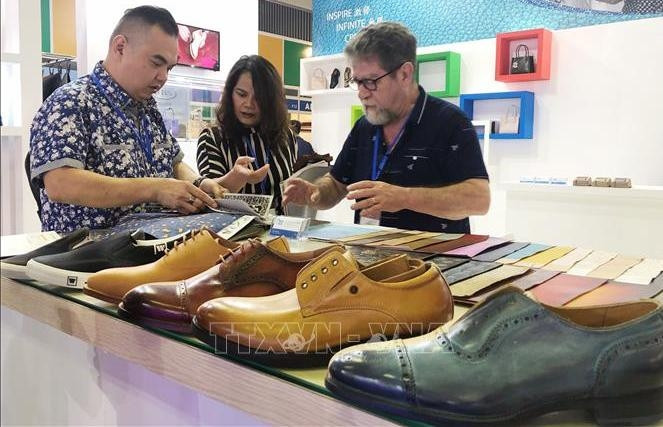 Visitors examining some products on display at the exhibition. (Photo: VNA)