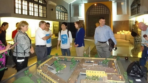 Two Hanoikids’ members (in white T-shirts) exchanging talks with US servicemen, including US General Herbert Carlisle, during a tour to Hoa Lo prison (Source: Hanoikids)