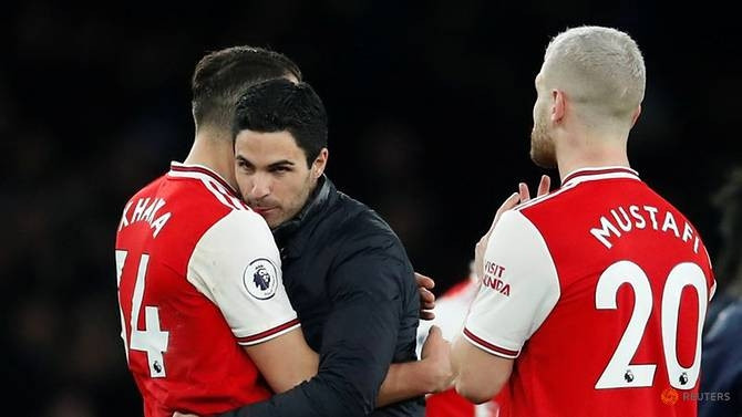Soccer Football - Premier League - Arsenal v Everton - Emirates Stadium, London, Britain - February 23, 2020 Arsenal manager Mikel Arteta celebrates with Granit Xhaka and Shkodran Mustafi after the match. (Reuters)