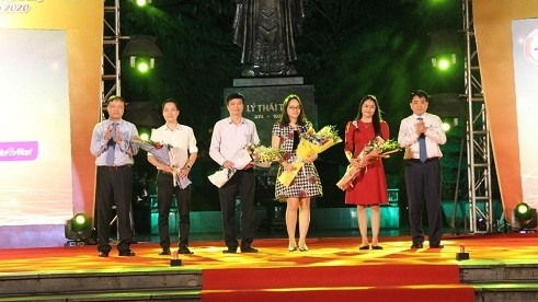 Chairman of Hanoi People’s Committee Nguyen Duc Chung presents flowers to enterprises participating in the programme.