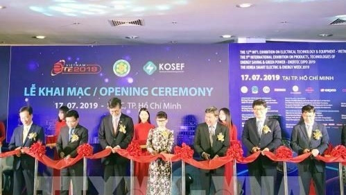 Delegates cut the ribbon to open the exhibition