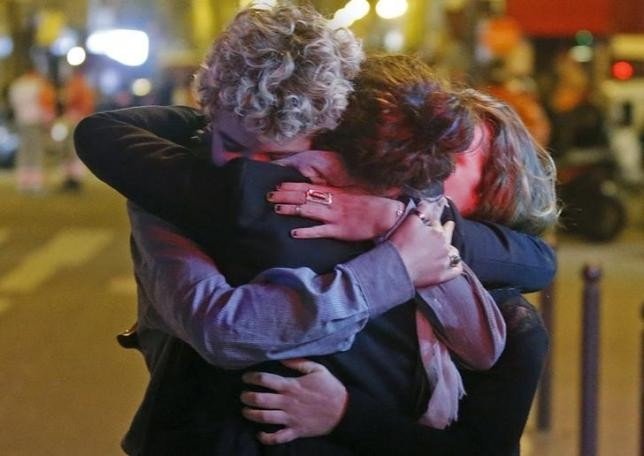 People hug on the street near the Bataclan concert hall following fatal attacks in Paris, France, November 14. (Credit: REUTERS)