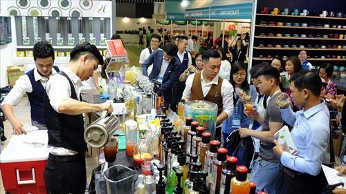 Visitors sample coffees and beverages at the exhibition.