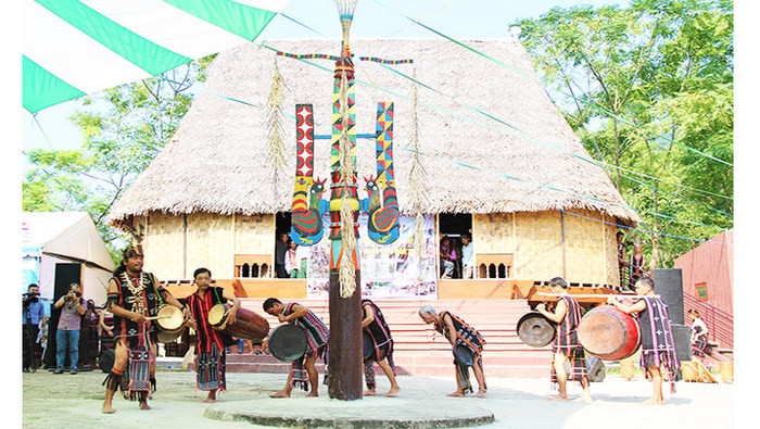 The dancing group is led by the village patriarch, followed by men and boys.