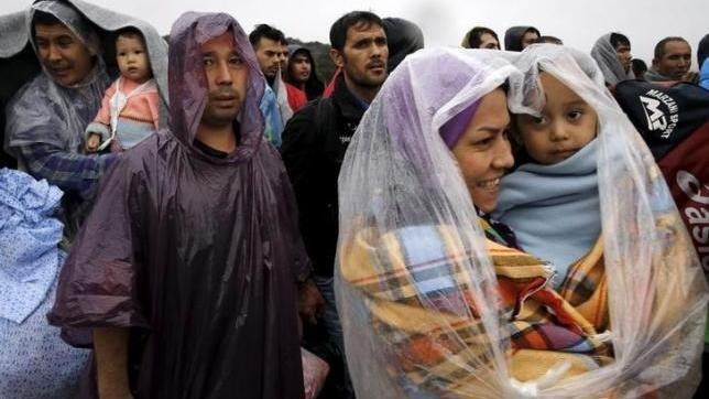 Afghan migrants wait to board a bus on their way to the nearest registration camp on the Greek island of Lesbos October 22, 2015.