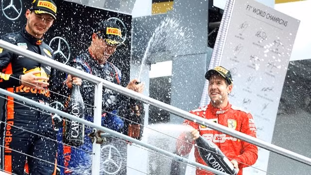 Formula One F1 - German Grand Prix - Hockenheimring, Hockenheim, Germany - July 28, 2019 Race winner Max Verstappen of Red Bull, third placed Daniil Kvyat of Toro Rosso and second placed Sebastian Vettel of Ferrari spray champagne on the podium after the race. (Photo: Reuters)