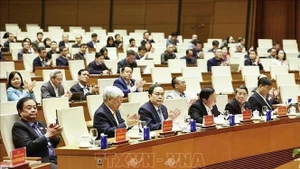Politburo member, Secretary of the NA Party Committee and NA Chairman Tran Thanh Man (front, centre) and other officials at the briefing on the 14th National Party Congress's outcomes on January 26. (Photo: VNA)