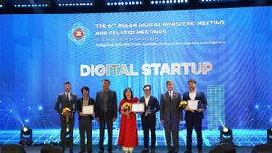 A representative of MedCAT (in red) receives the Gold Award in the startup category.