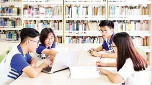 Students at Viet Nam National University, Ha Noi, look up materials at the university’s information and library centre. (Photo: DUONG TAM)