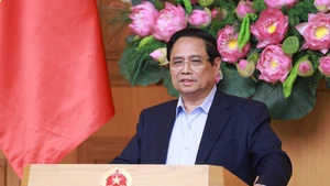 PM Pham Minh Chinh addresses the conference reviewing the one-month operation of the two-tier local government model on July 28. (Photo: VNA)