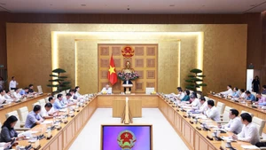 Prime Minister Pham Minh Chinh addresses a conference reviewing one month of running the two-tier local administration system on July 28. (Photo: VNA)