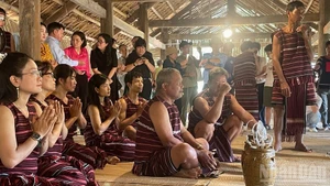 Visitors attend an event featuring the re-enactment of a Cho Ro worship ceremony (Dong Nai) at the Viet Nam National Village for Ethnic Culture and Tourism.