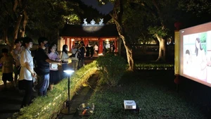 Visitors take part in the “Temple of Literature – Quoc Tu Giam” night experience tour. (Photo: THANH NGUYEN)