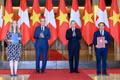 General Secretary of the Communist Party of Viet Nam Central Committee and President To Lam (second from right) and Swiss President Guy Parmelin (second from left) witness the exchange of cooperation documents between ministries and agencies. (Photo: nhandan.vn)