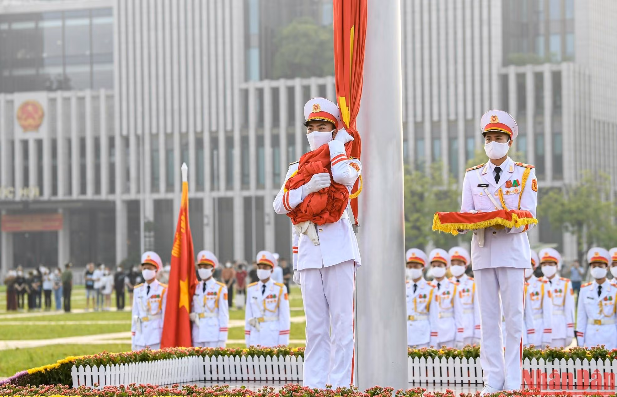 The soldier who holds the red flag waits for the command and the national anthem. The soldier who holds the red flag waits for the command and the national anthem.
