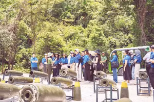 Visitors explore the outdoor exhibition of unexploded ordnance remnants at the Command Bunker.