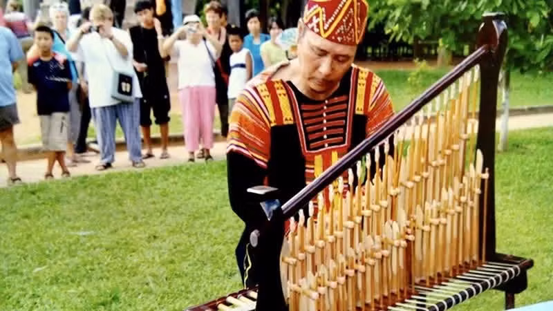 People’s Artist Dong Van Minh performs the bamboo instrument at the Viet Nam Museum of Ethnology. (Photo supplied by the artist)