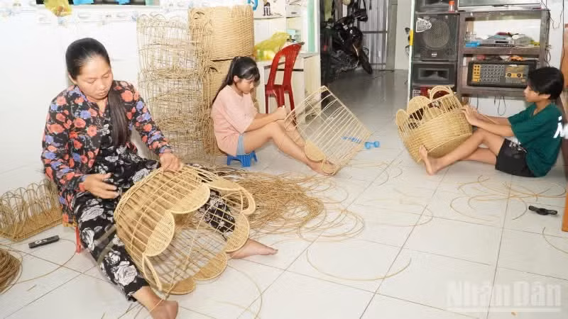 Mai Thi Kim Phung and her family members are putting the finishing touches on their products.