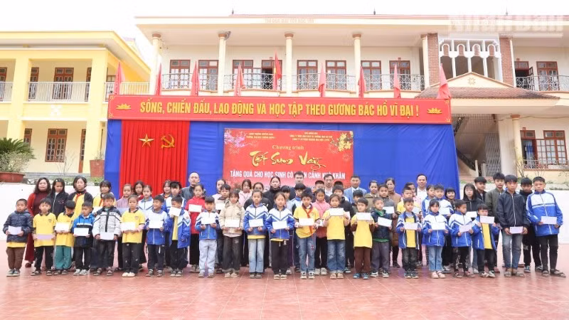 Representatives from various organisations present Tet gifts to 62 disadvantaged students at Chieng Ngan A Primary and Secondary School. (PHOTO: PHAN THAO)