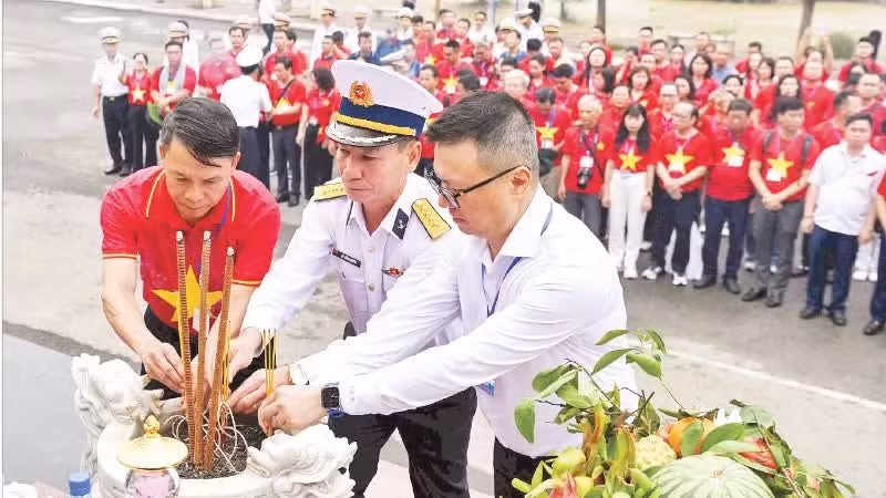 Le Quoc Minh, Editor-in-Chief of Nhan Dan Newspaper, and leaders of Task Force No. 25, along with the team of journalists, offer incense at the Monument commemorating the heroic soldiers of the “No Number” naval convoy. (Photo: DUC NGHIA)
