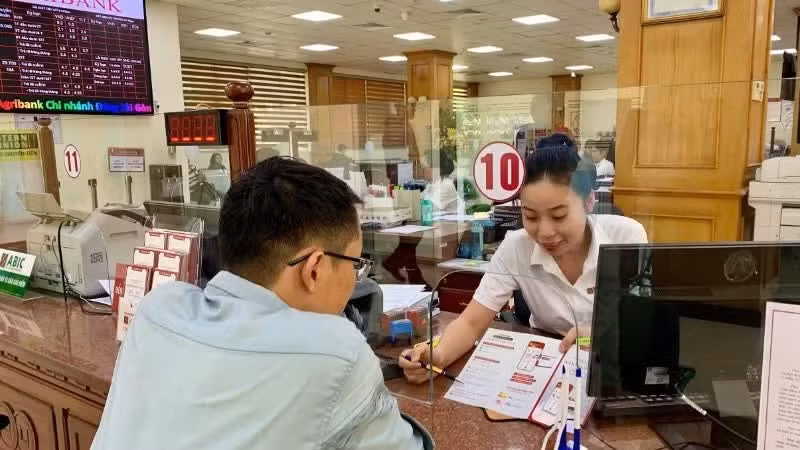 Customers transact at Agribank branches in Ho Chi Minh City.