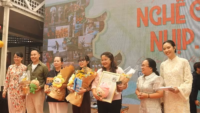 Delegates present flowers to guests at the exchange programme. (Photo: Organising Committee)