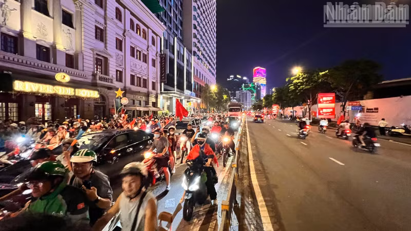 Ho Chi Minh City fans joyfully take to the streets, waving flags to celebrate the victory of the Vietnamese men's football team. (Photo: The Anh)