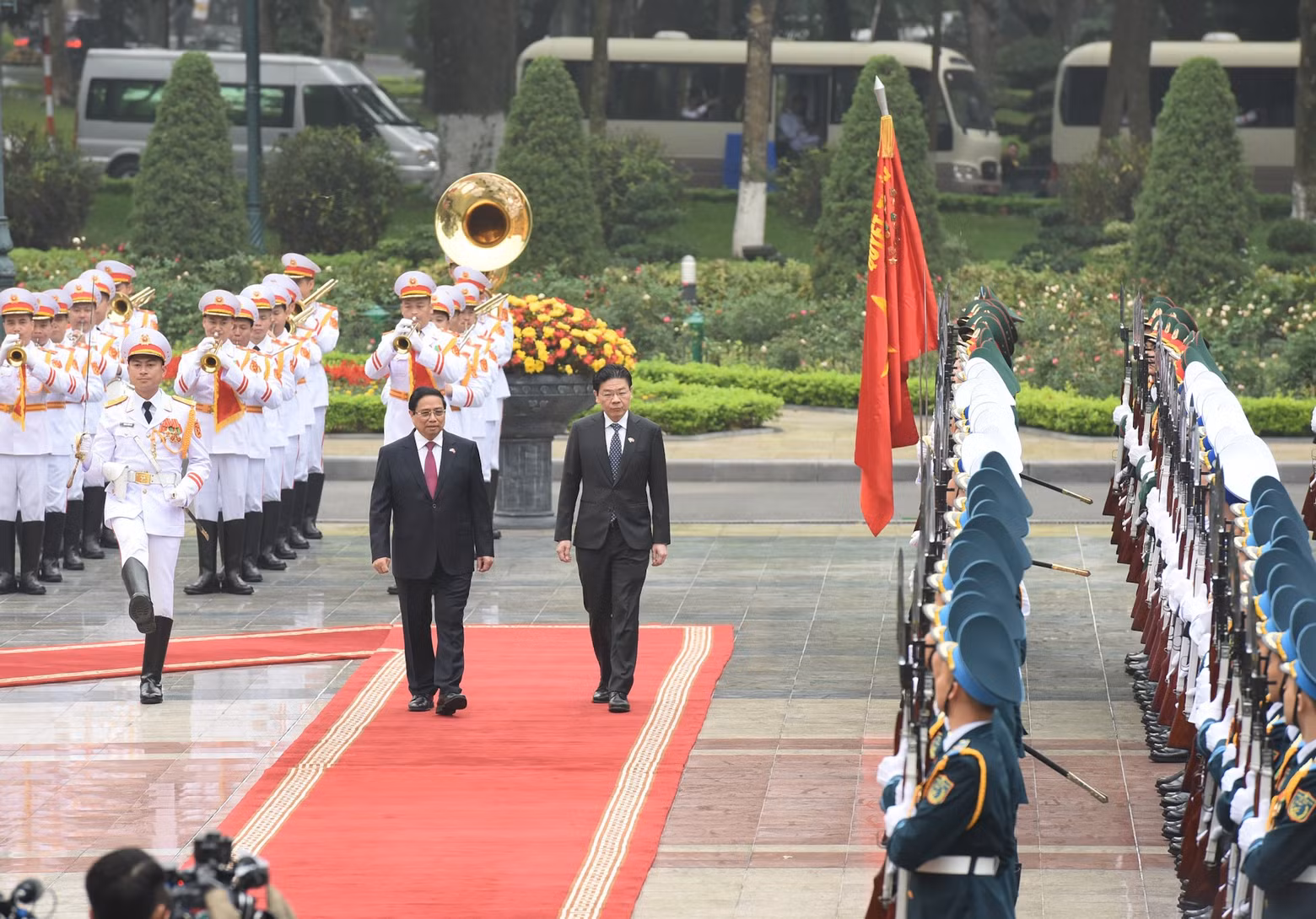PM Pham Minh Chinh and Singaporean PM Lawrence Wong review the guard of honour.