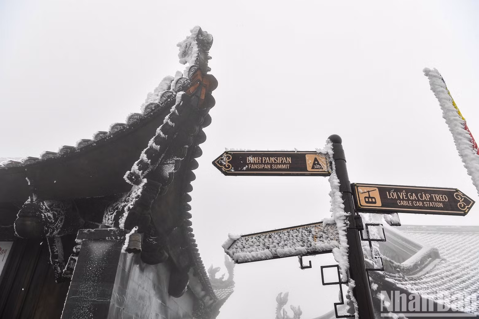 Snow covers the roof of a temple.