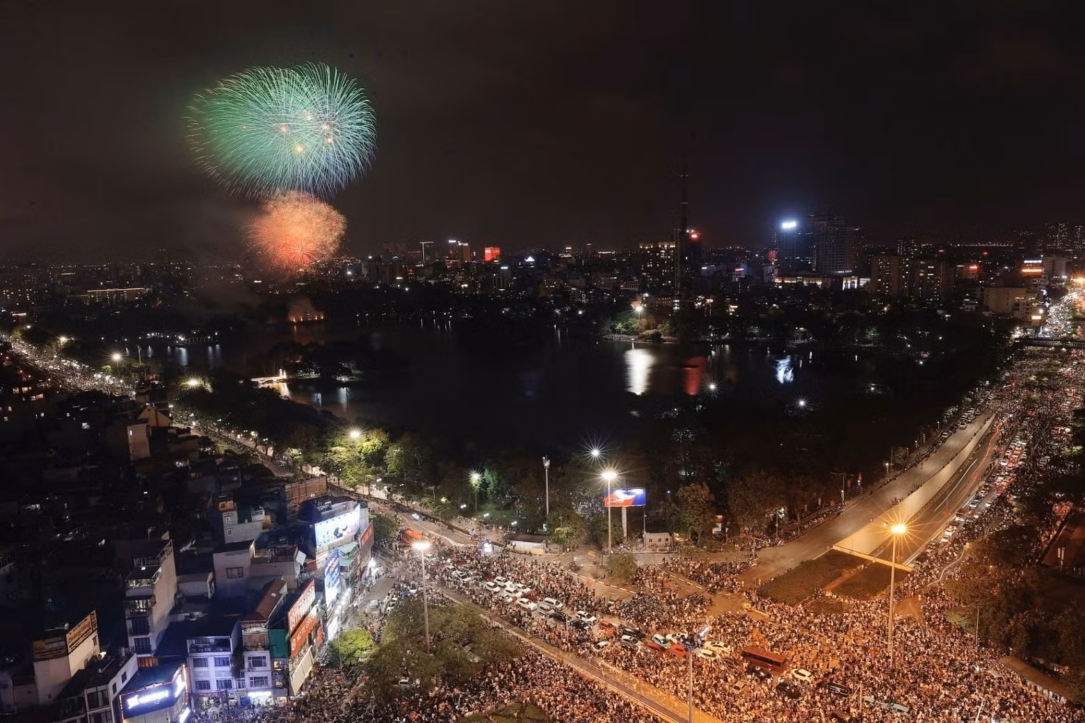 The capital city residents gather at Thong Nhat Park to watch the fireworks display.