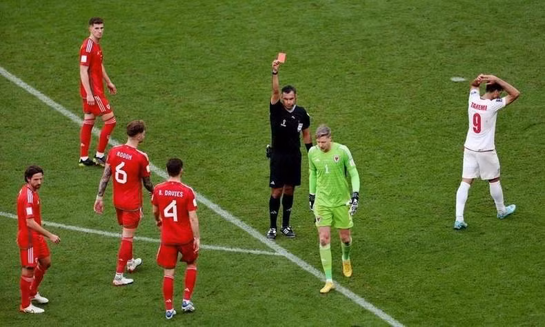 Wales' Wayne Hennessey is shown a red card by referee Mario Escobar. REUTERS/Marko Djurica