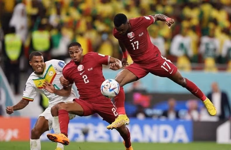 Qatar's Ismail Mohamad and Pedro Miguel in action with Senegal's Ismail Jakobs. REUTERS/Amr Abdallah Dalsh