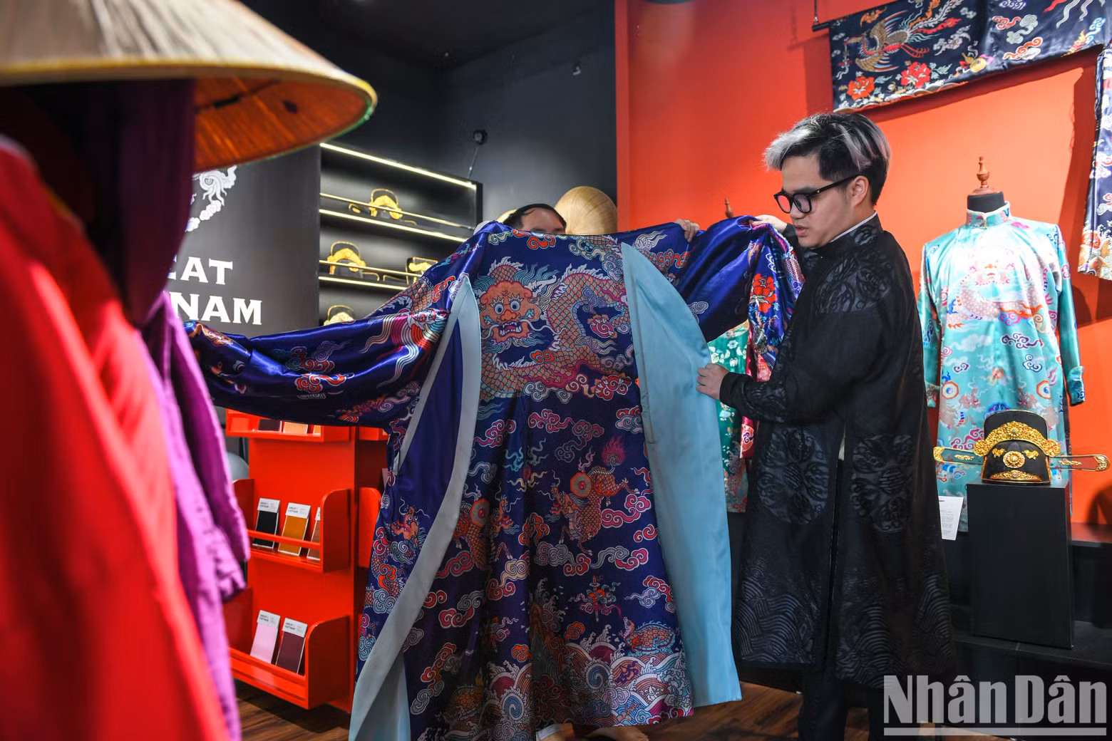 Vu Duc next to a model of ancient costume that was painstakingly restored. Vu Duc next to a model of ancient costume that was painstakingly restored.