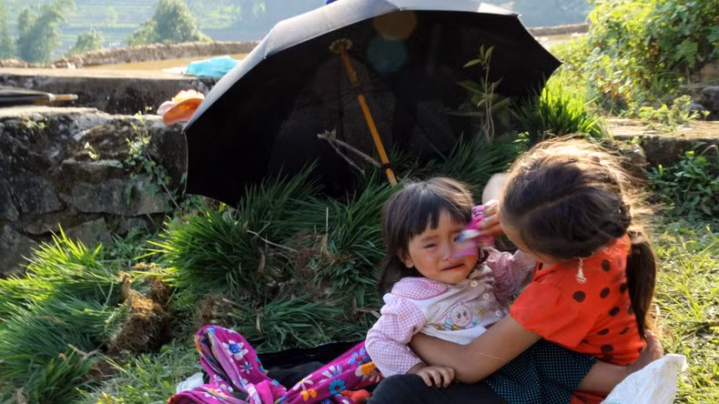 Children look after their younger siblings right in the field so that their parents can feel secure in sowing seeds and ensuringthe harvest time.