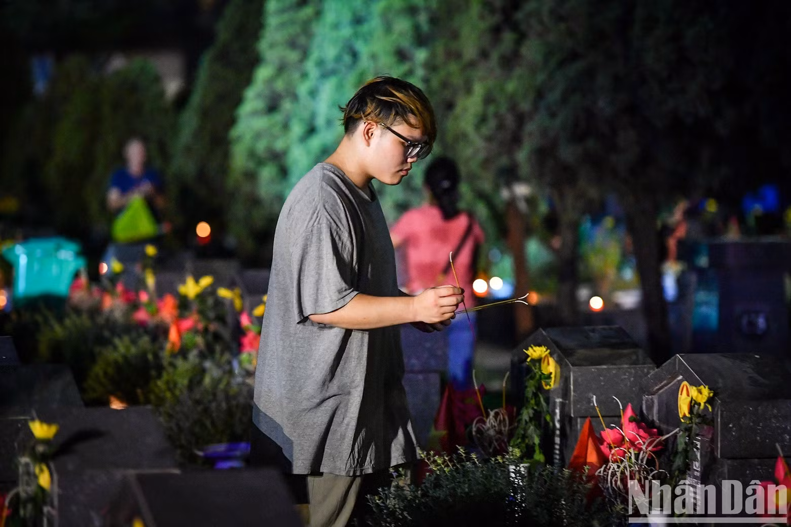 A young man pays tribute to fallen soldiers. A young man pays tribute to fallen soldiers.
