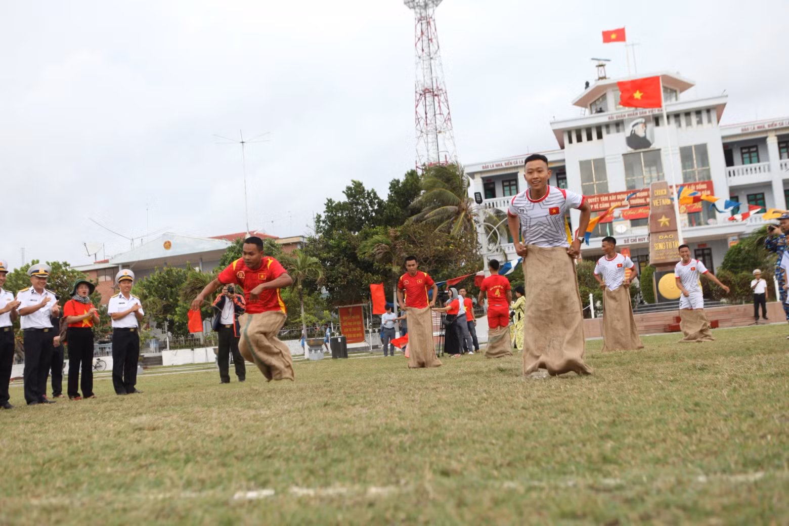 People participate in a sack race competition.