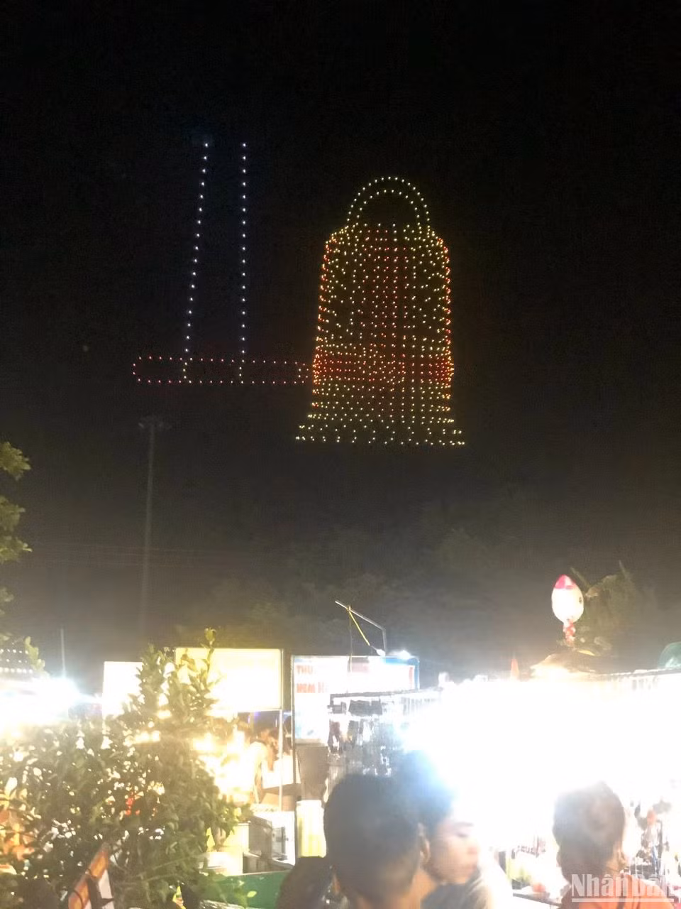 In the sky above the historic river, light moves and converges into the "Peace Bell".