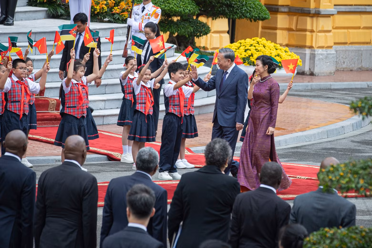 General Secretary and President To Lam and his wife wave at the children.