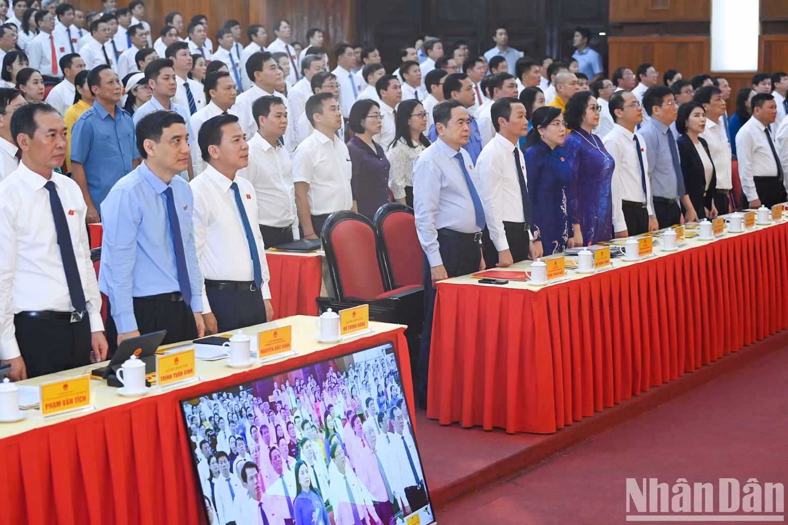 Delegates perform the flag salute ceremony.