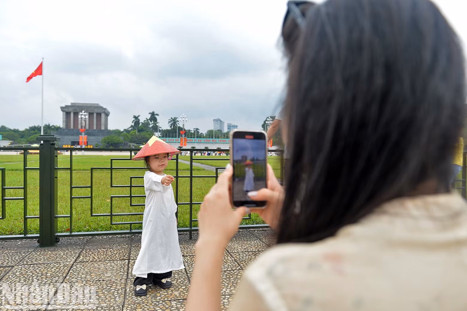 A little girl poses for a photo at Ba Dinh Square.