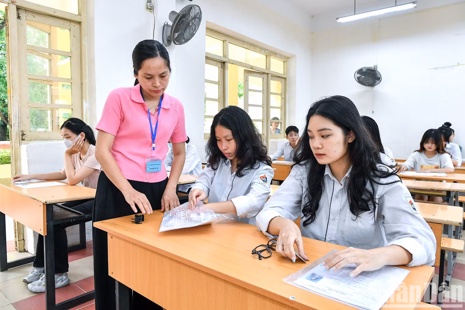 An invigilator proctoring the exam at a test room in Hanoi.