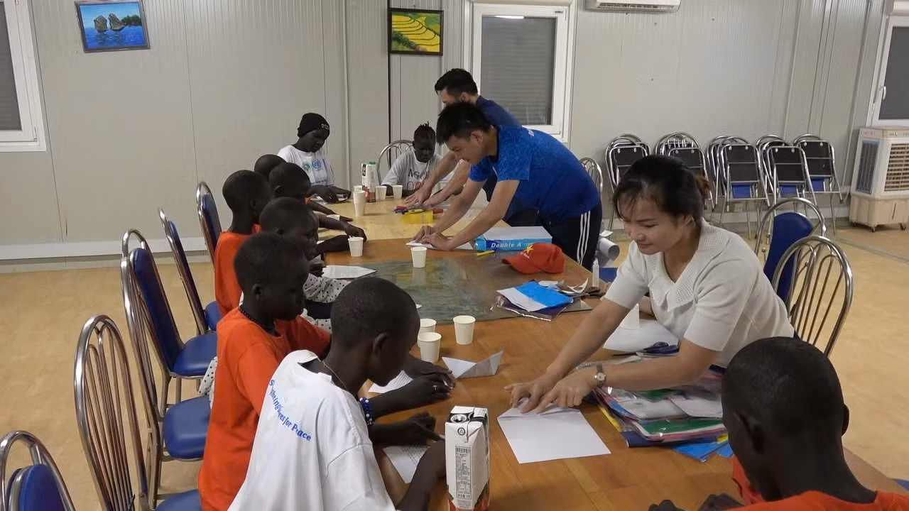 Guiding the children in making toys.