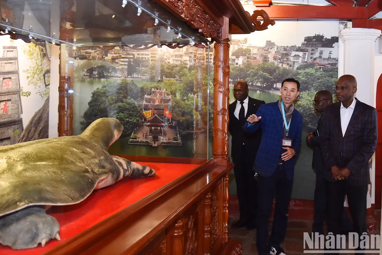 Togolese Foreign Minister Robert Dusse listens to an introduction to the Hoan Kiem Lake turtle specimen at the Ngoc Son Temple exhibition house.