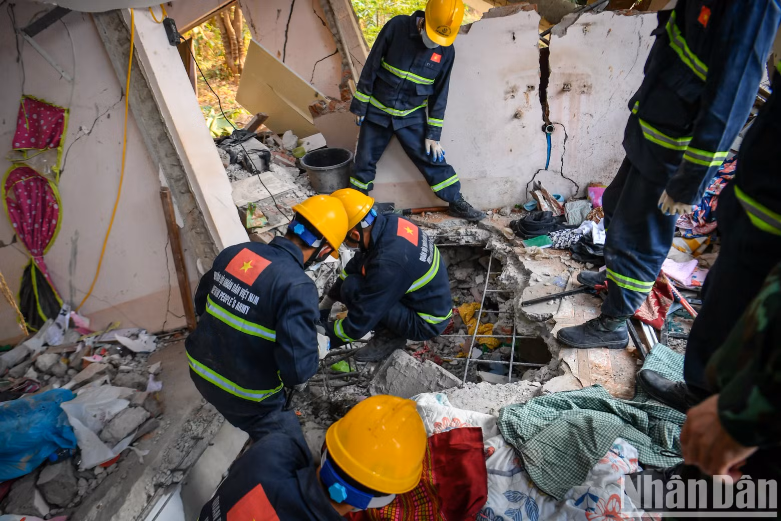Vietnamese military rescue forces carefully remove each stone to prevent dangerous tremors that could endanger those conducting the mission and to avoid causing further harm to the victim