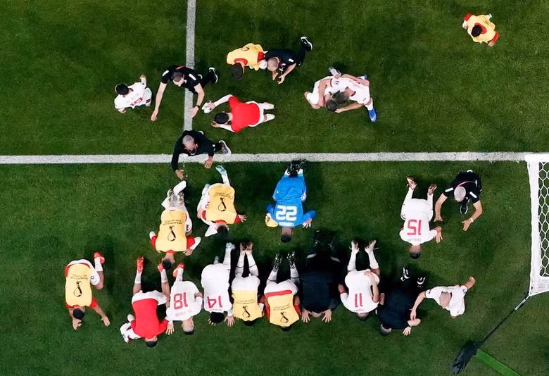 Morocco players celebrate qualifying for the knockout stages after their match against Canada. (Photo: REUTERS)