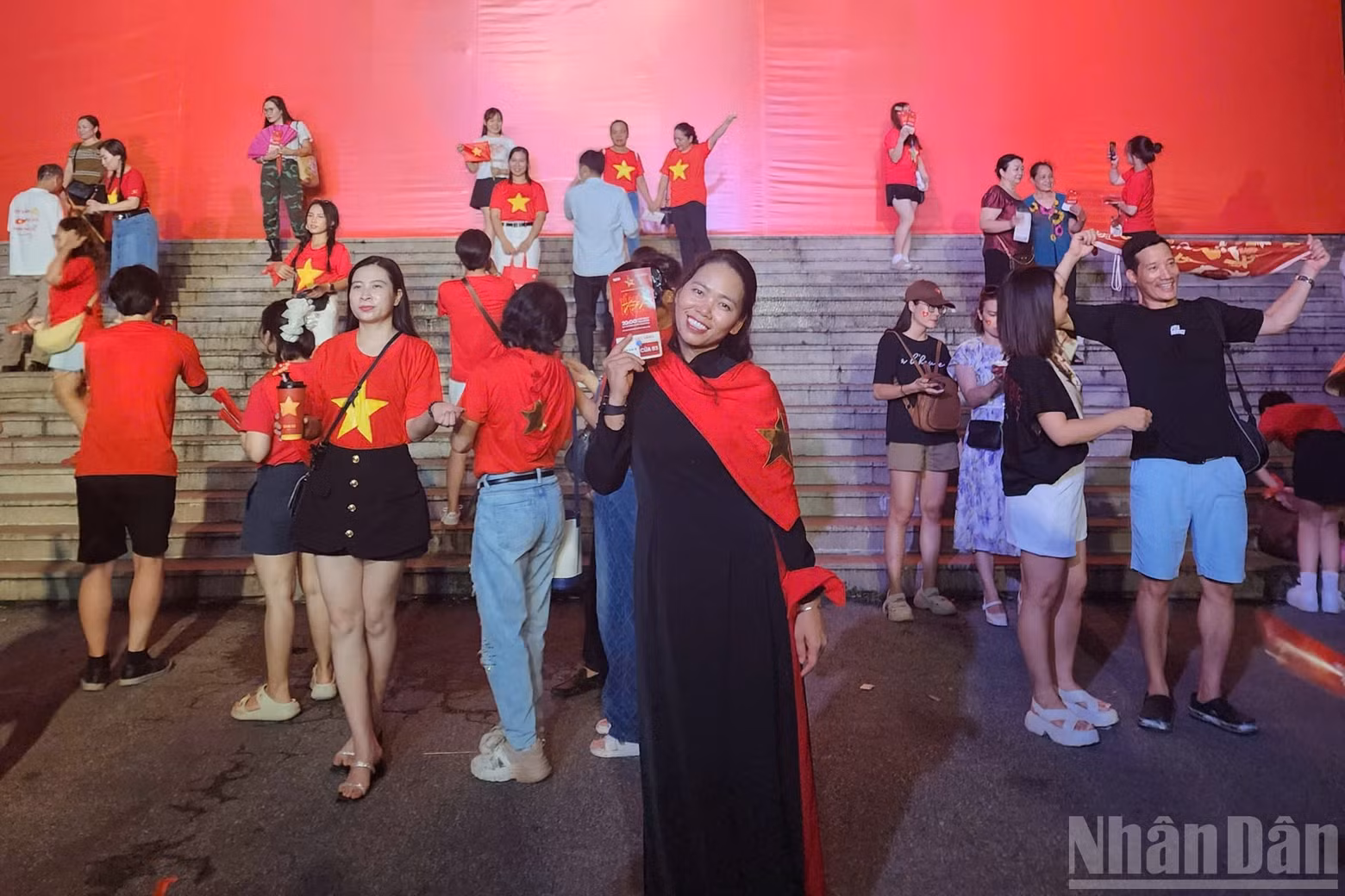 Audience Tran Thi Bich Thuy takes the opportunity to snap a keepsake photo in front of the stadium.