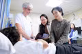 Madame Ngo Phuong Ly visits a patient under treatment at HUDERF (Photo: VNA)